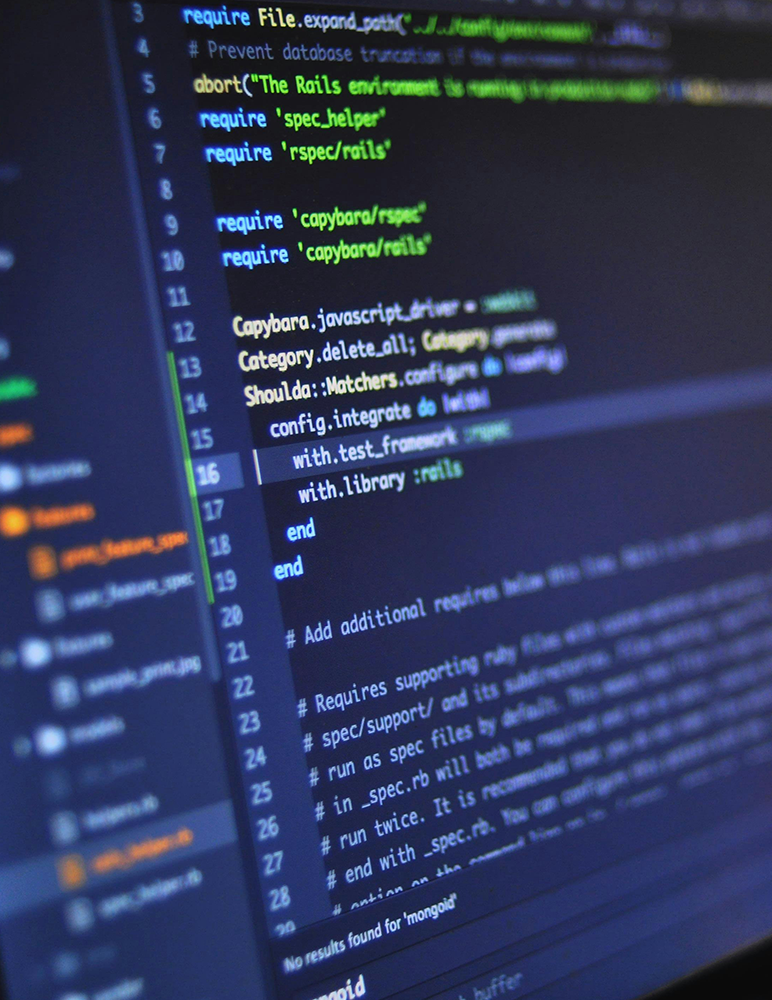 Blurry image of Ruby on Rails code in an IDE on a laptop